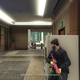 A man in a dark blue shirt takes cover behind a vending machine while police shoot at him.